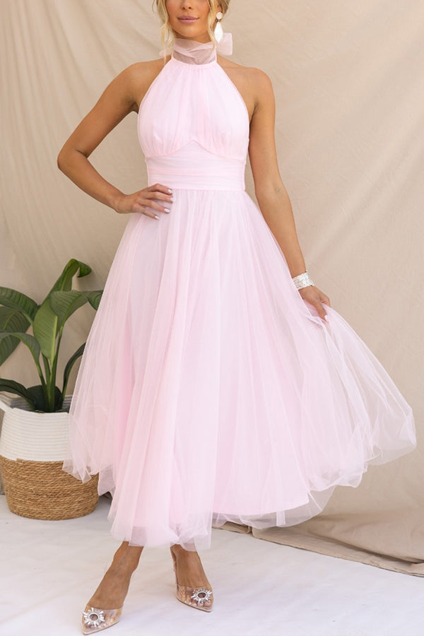 Back view of an elegant women's whimsical tulle midi dress, perfect as a wedding guest or cocktail dress.