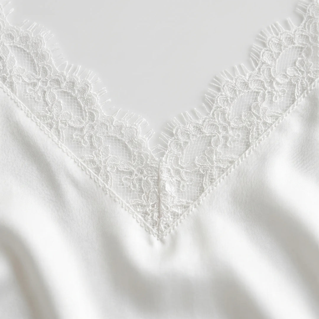 Full shot of a women's backless white A-line mini dress, ideal for summer events & beach parties.