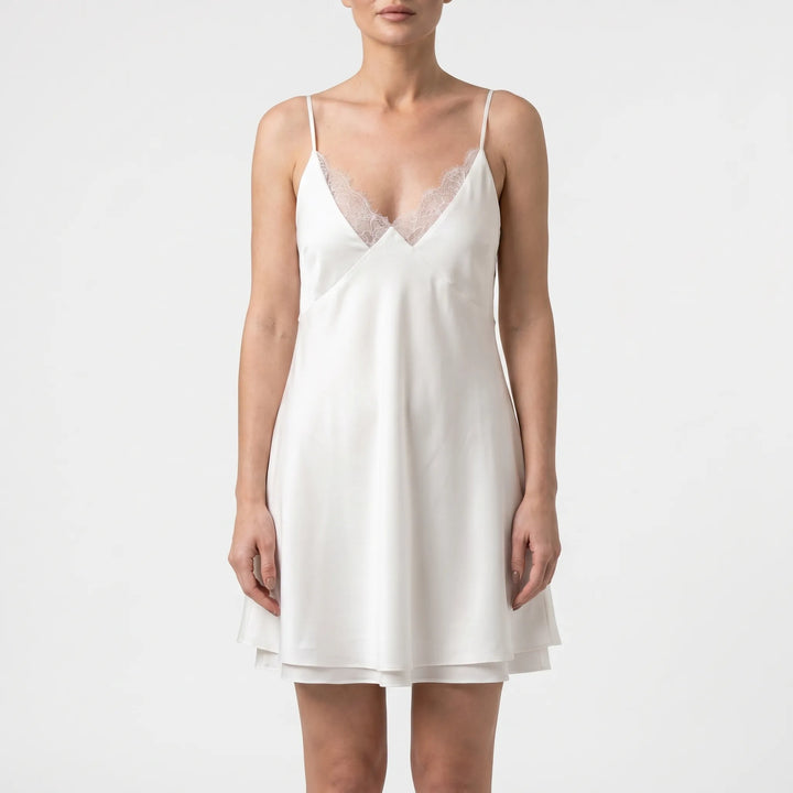 Chic women's white backless mini dress with flowy A-line skirt, versatile for parties or summer outings.