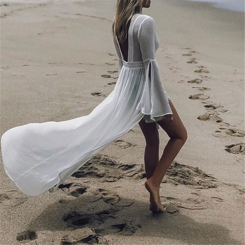 Bohemian white maxi vacation dress for women. Open back design & flowy flare sleeves, great for summer parties.