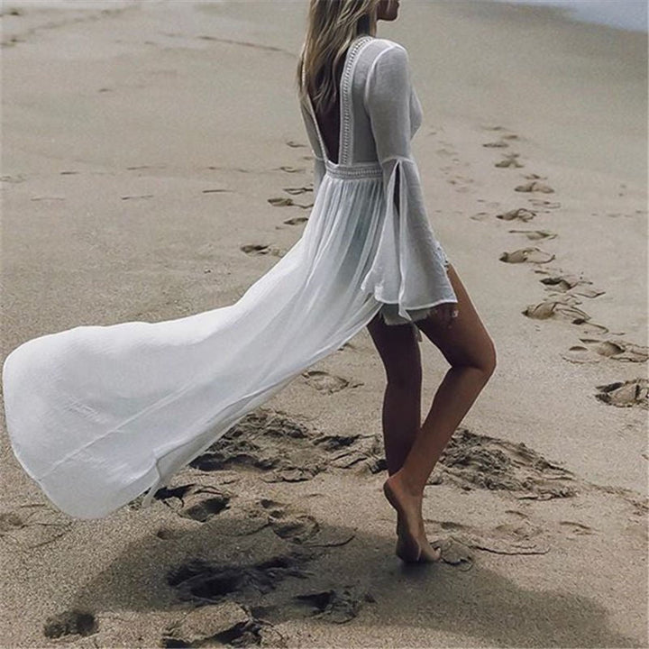 Bohemian white maxi vacation dress for women. Open back design & flowy flare sleeves, great for summer parties.