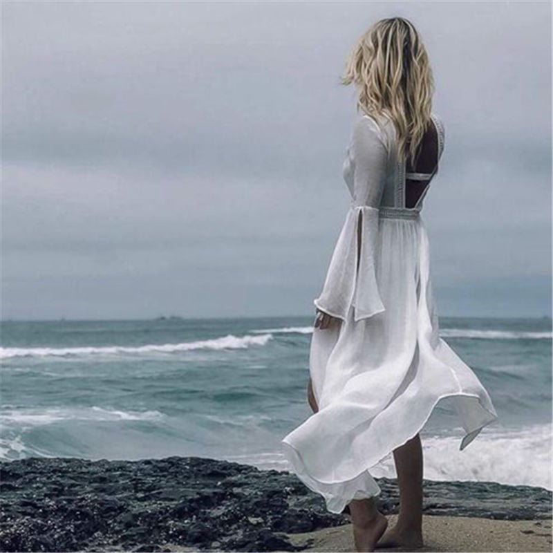 Light & airy white maxi summer dress for women. Features an open back & beautiful flare sleeves. Great for beach holidays.