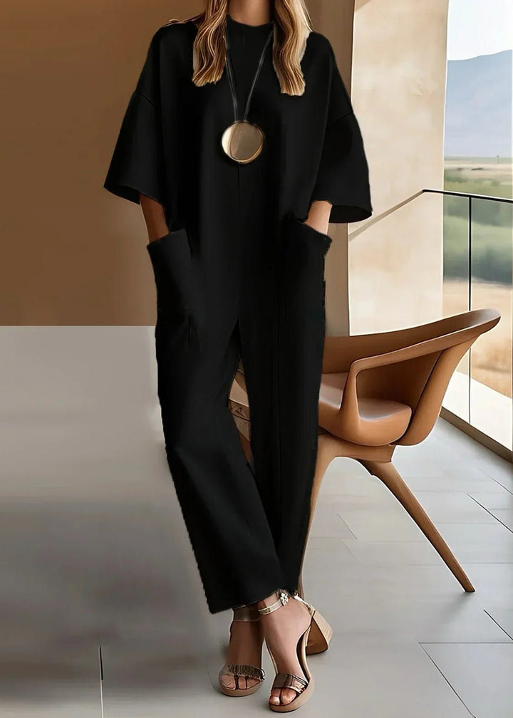 Elegant women's black wide leg jumpsuit with short sleeves. Versatile, relaxed fit for casual or dressy wear.