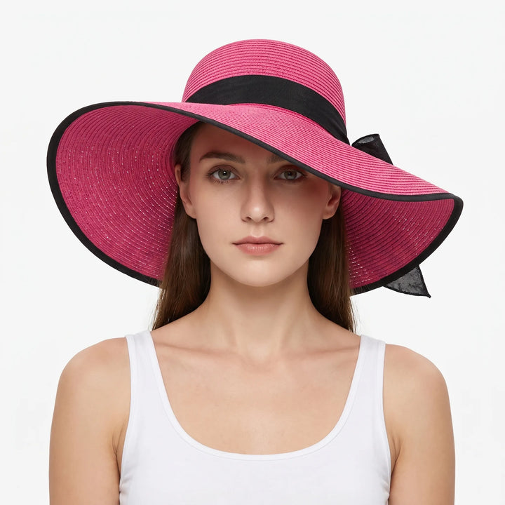 Chic women's packable travel sun hat with a wide floppy brim, perfect for beach vacations & resort wear.