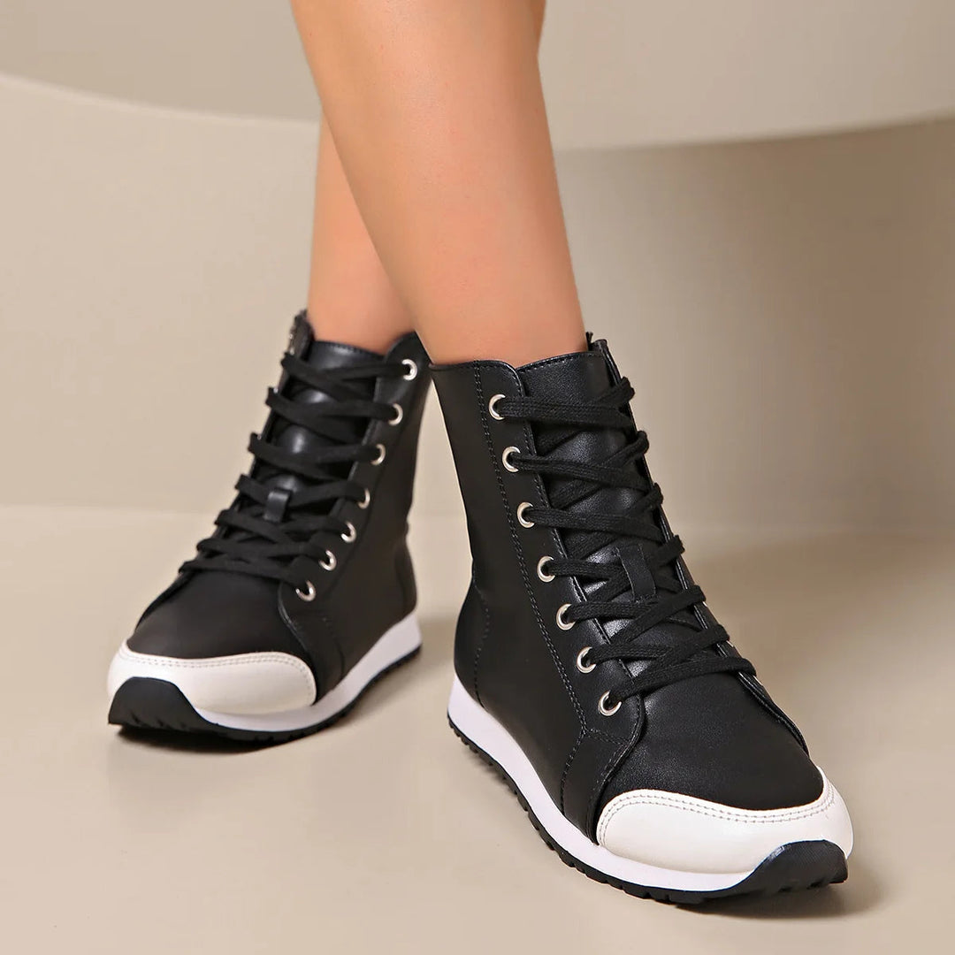 Detail of women's wide fit orthopedic lace-up sneaker, showing supportive sole and breathable upper for comfort.
