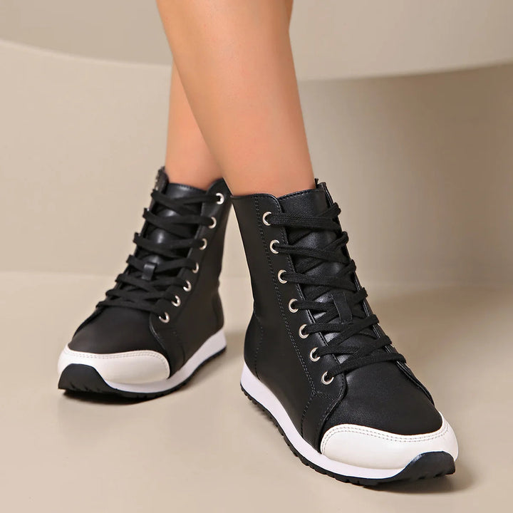 Detail of women's wide fit orthopedic lace-up sneaker, showing supportive sole and breathable upper for comfort.
