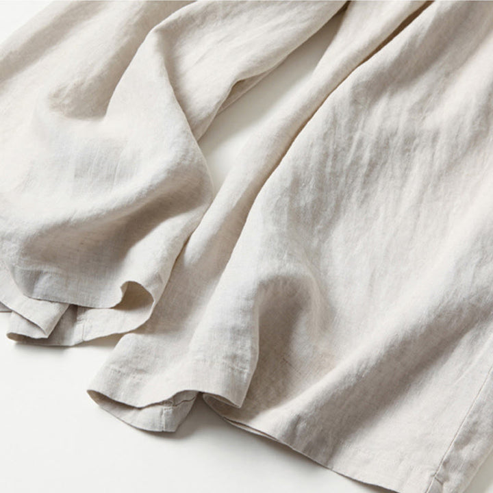 Close-up of comfortable fabric on women's wide-leg trousers, high-waist detail visible.