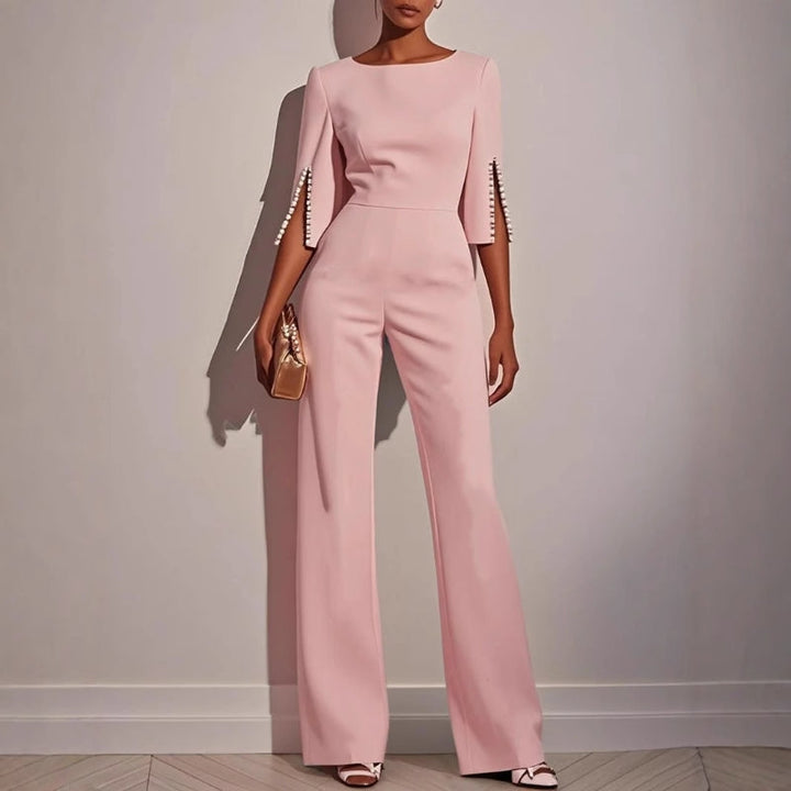 Sophisticated women's wide leg jumpsuit showcasing delicate pearl-detailed sleeves, for modern elegance.