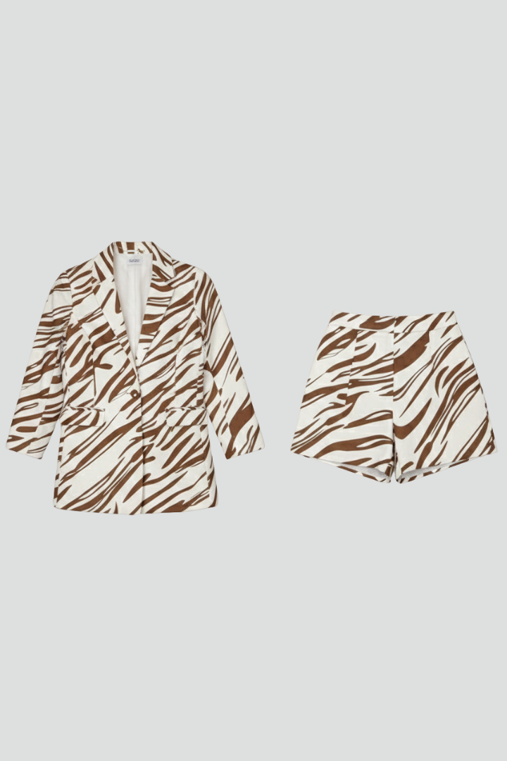Detail of wild animal print fabric on a women's blazer & shorts co-ord set. Trendy two-piece pattern.