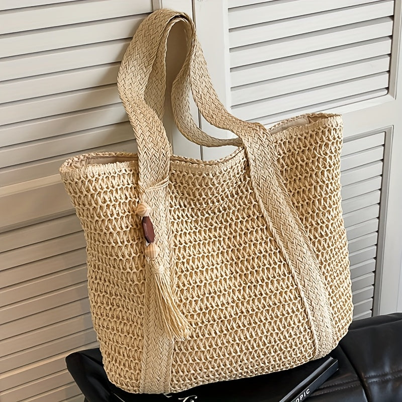 Green woven straw tote bag for women, designed with a chic fringe tassel, perfect for beach days.