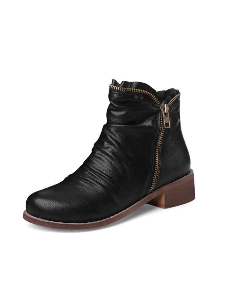 Women's wrinkled low heel western ankle boots with double zip closure.