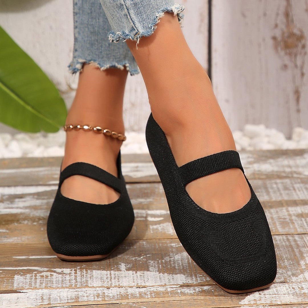 Stylish black women's Mary Jane ballet flats, slip-on, with a unique smiling face and adjustable strap for comfort.