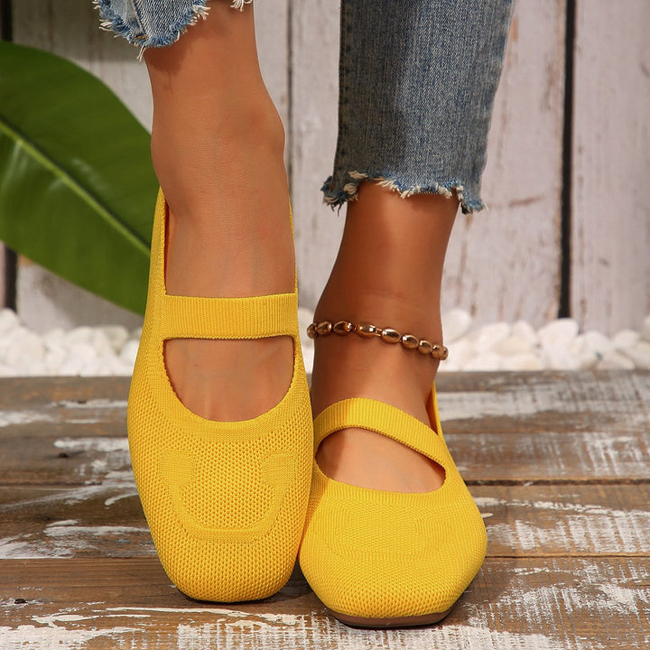 Yellow women's Mary Jane ballet flats, slip-on, with a joyful smiling face and an adjustable strap for ultimate comfort.