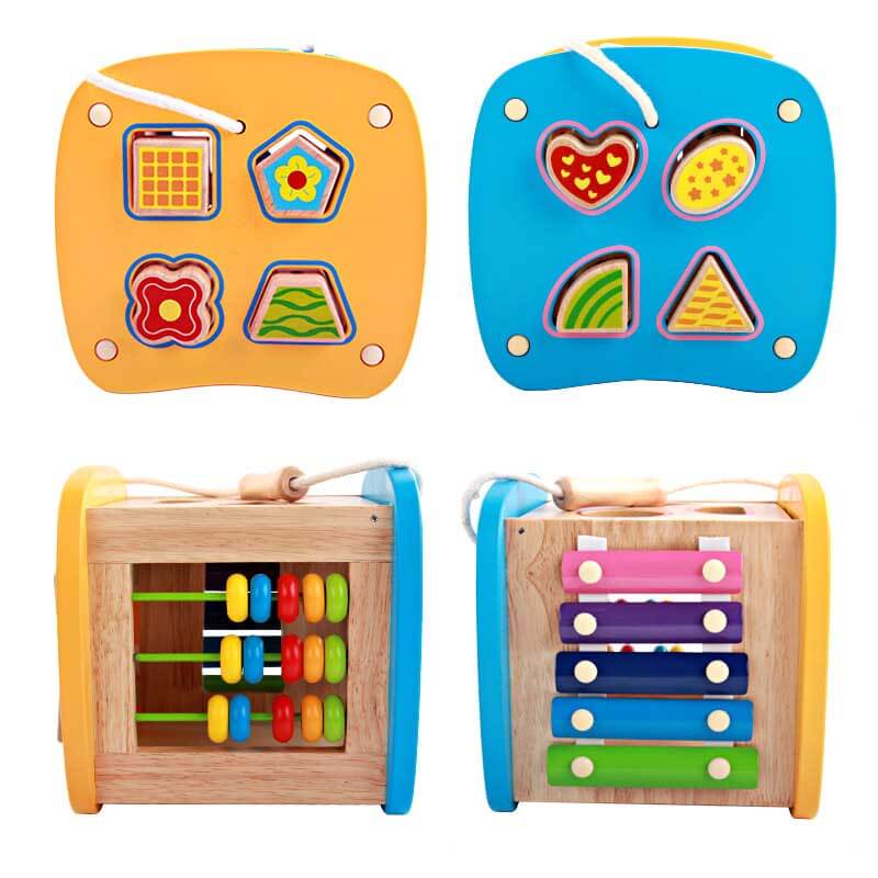 Toddler wooden activity cube displaying a clock and various manipulative elements for learning.
