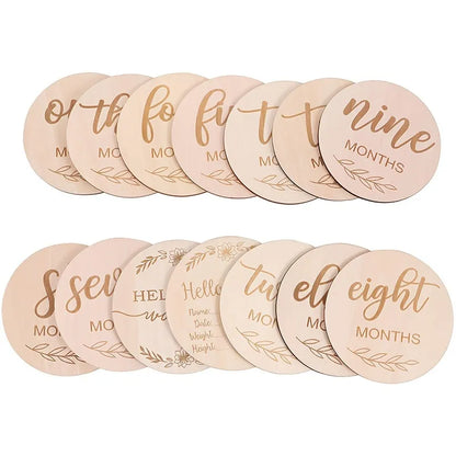 Set of 14 double-sided wooden baby milestone discs for monthly growth photos, newborn to one year.