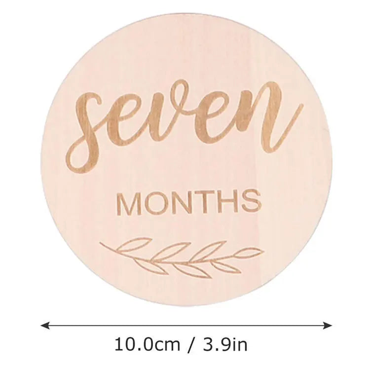 Unisex wooden baby milestone discs, each double-sided, a thoughtful baby shower and newborn gift.
