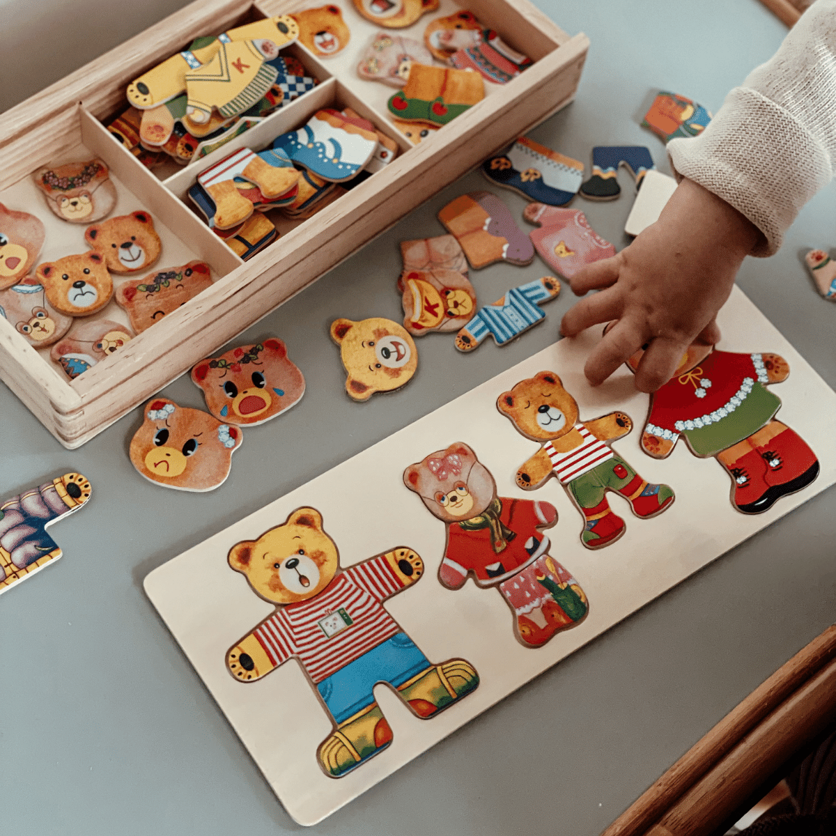 Wooden bear dress-up puzzle for toddlers, teaching cognitive skills.