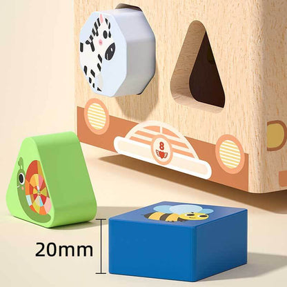 Child's hand placing a block into the wooden shape sorting toy car, building motor skills.