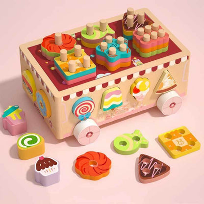 Child playing with a wooden shape sorter toy car, developing motor skills and learning shapes.