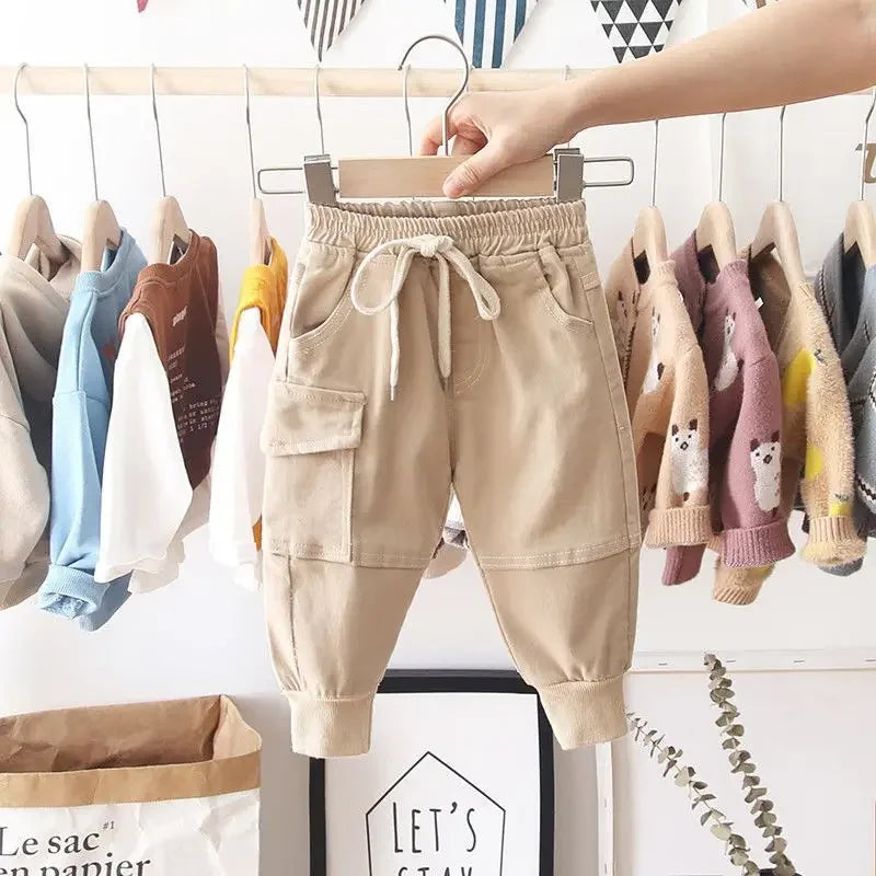 Young boy wearing durable khaki cargo play pants, perfect for active toddlers