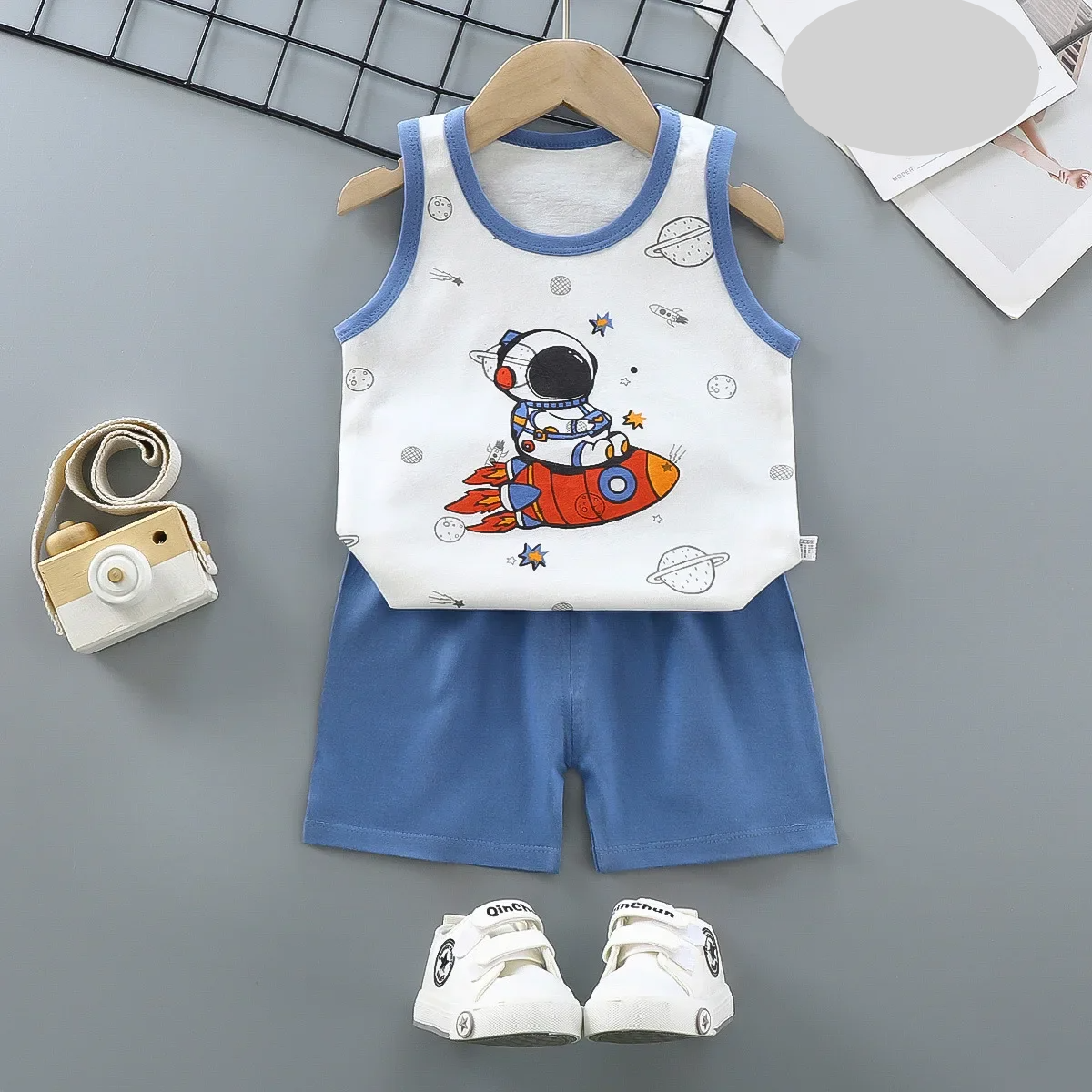 Blue children's activewear set laid flat, showcasing the lightweight top and elastic waist shorts.