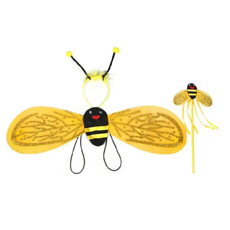 Girl smiling in her complete bee costume, including a comfortable black and yellow striped leotard, tutu, and large wings.