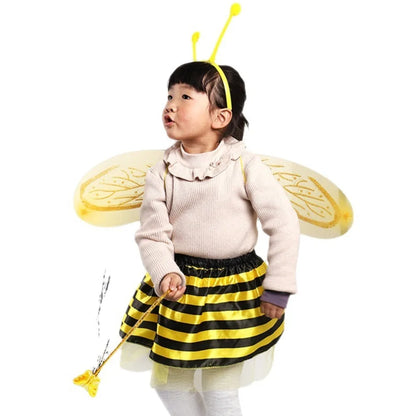 Full shot of a toddler girl in a charming bee costume, complete with a fluffy tutu, wings, and golden antennae on a headband.